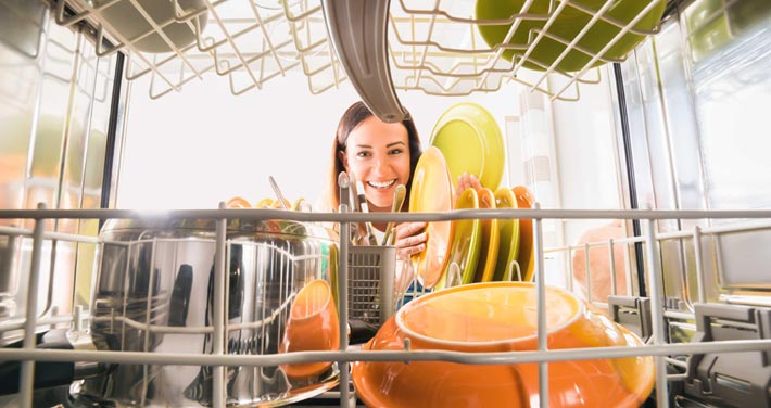 woman loading a dishwasher