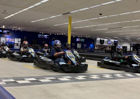 go-kart racers cross the finish line at the NH Motorplex indoor track