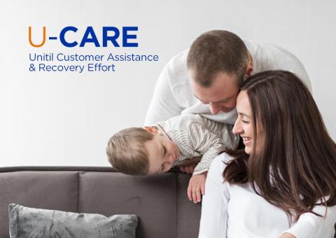 mother and father smile at their son on couch
